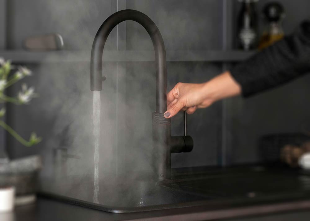 Quooker Boiling Water Tap with person turning tap